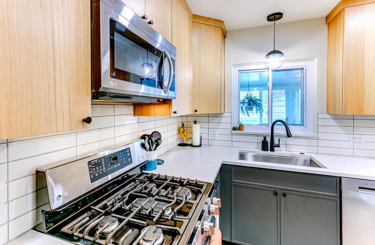 Close-up of custom kitchen range and sleek tile wall in Waterford, MI by Cabinet Creations