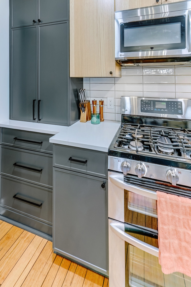 Custom home kitchen in Oakland County, MI featuring black hardware and natural wood details by Cabinet Creations