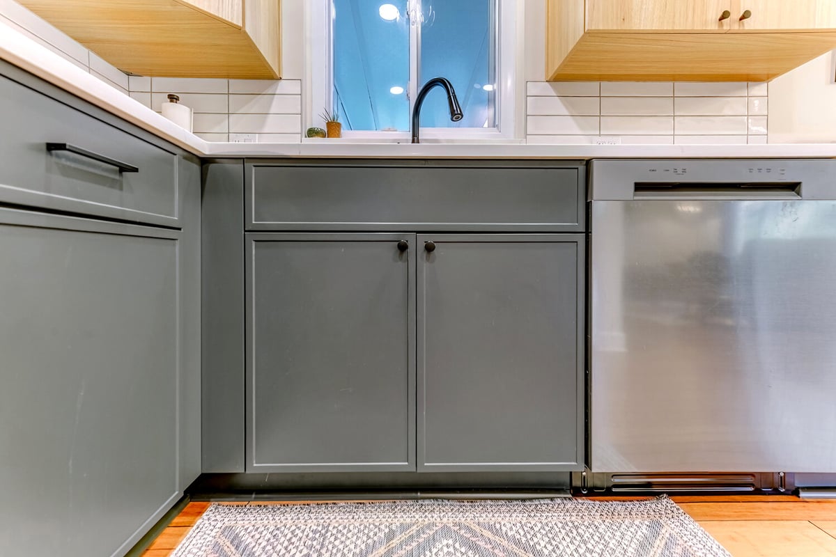 Custom kitchen in Oakland County featuring clean lines and dark green cabinetry by Cabinet Creations
