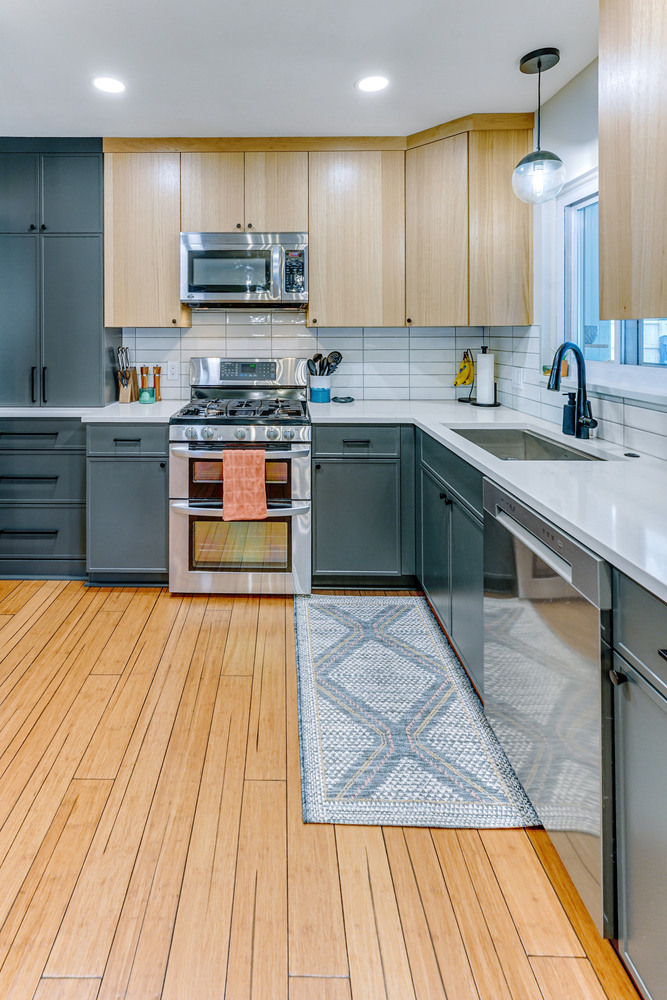 Modern U-shaped kitchen layout with bold two-tone cabinets by Cabinet Creations in Waterford Township, MI