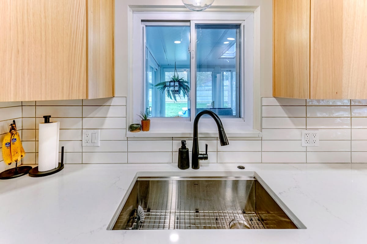 Oakland County custom kitchen with clean backsplash lines and dual outlet setup by Cabinet Creations