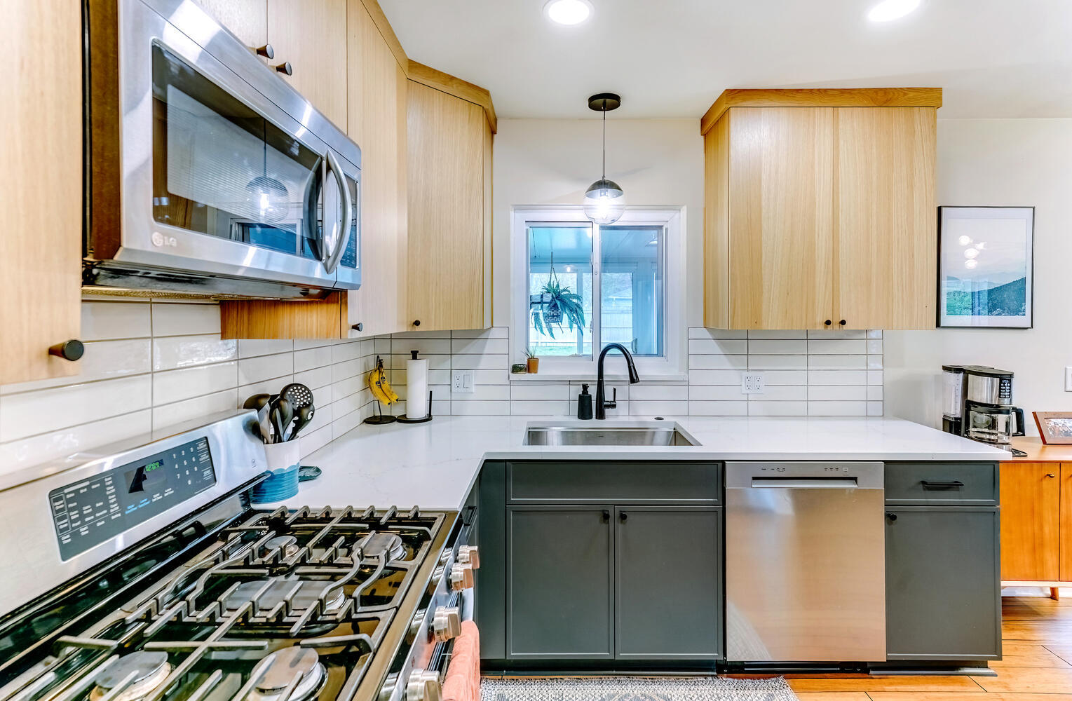 Clarkston custom kitchen highlighting clean lines, upper wood cabinetry, and lower dark cabinets by Cabinet Creations