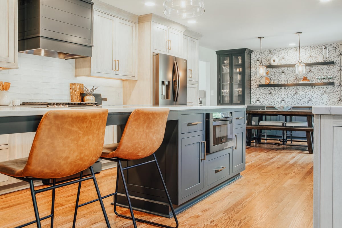 Modern kitchen island and seating area in a Clarkston custom home by Cabinet Creations