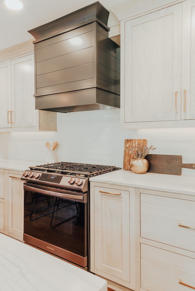 Modern kitchen remodel by Cabinet Creations in Clarkston showcasing sleek stainless range and custom wood cabinets