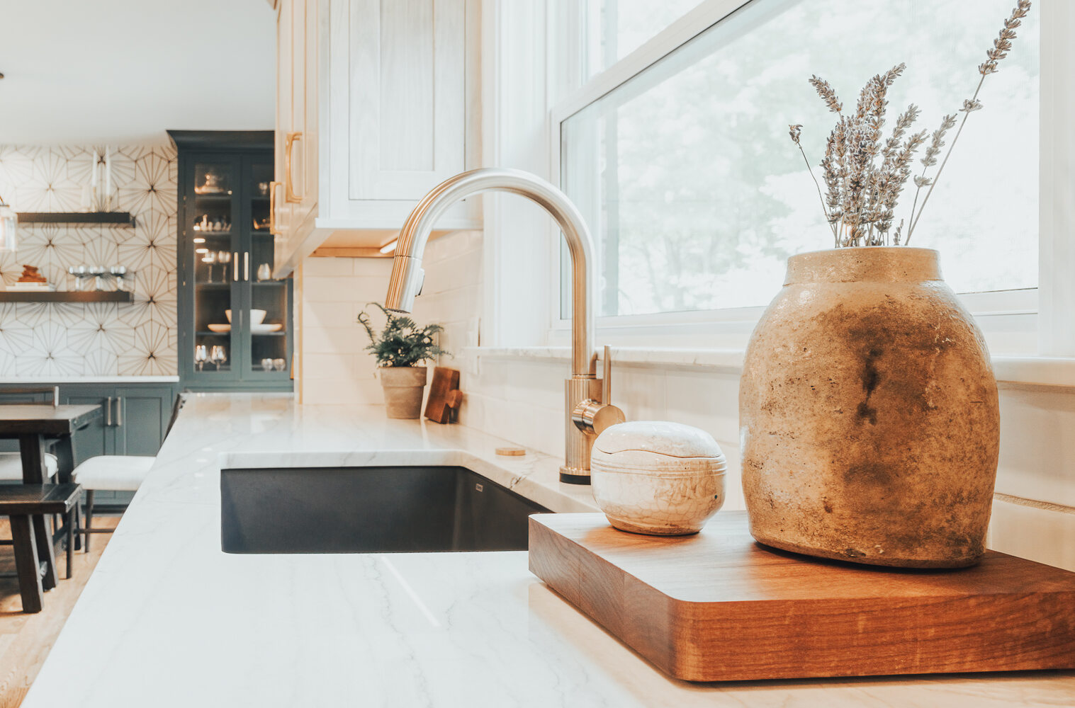 Quartz countertop and black sink design in custom Clarkston kitchen by Cabinet Creations