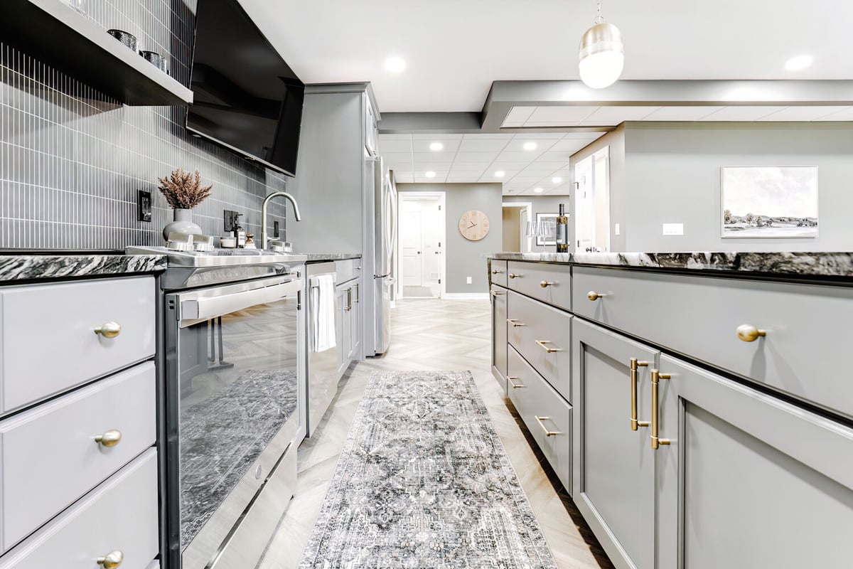 Basement kitchenette renovation by Cabinet Creations in Clarkston, MI with herringbone flooring and TV wall mount