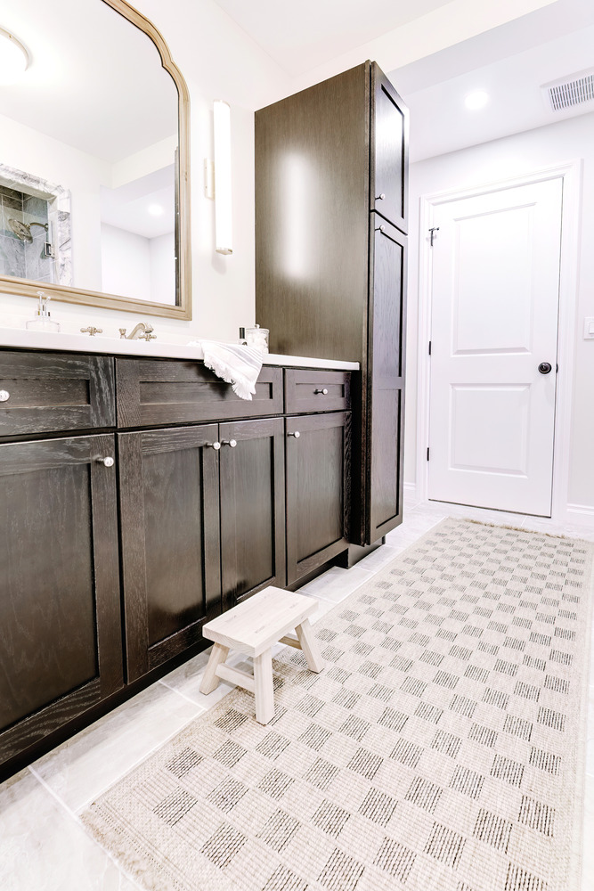 Child-friendly bathroom design with step stool in Clarkston basement remodel by Cabinet Creations