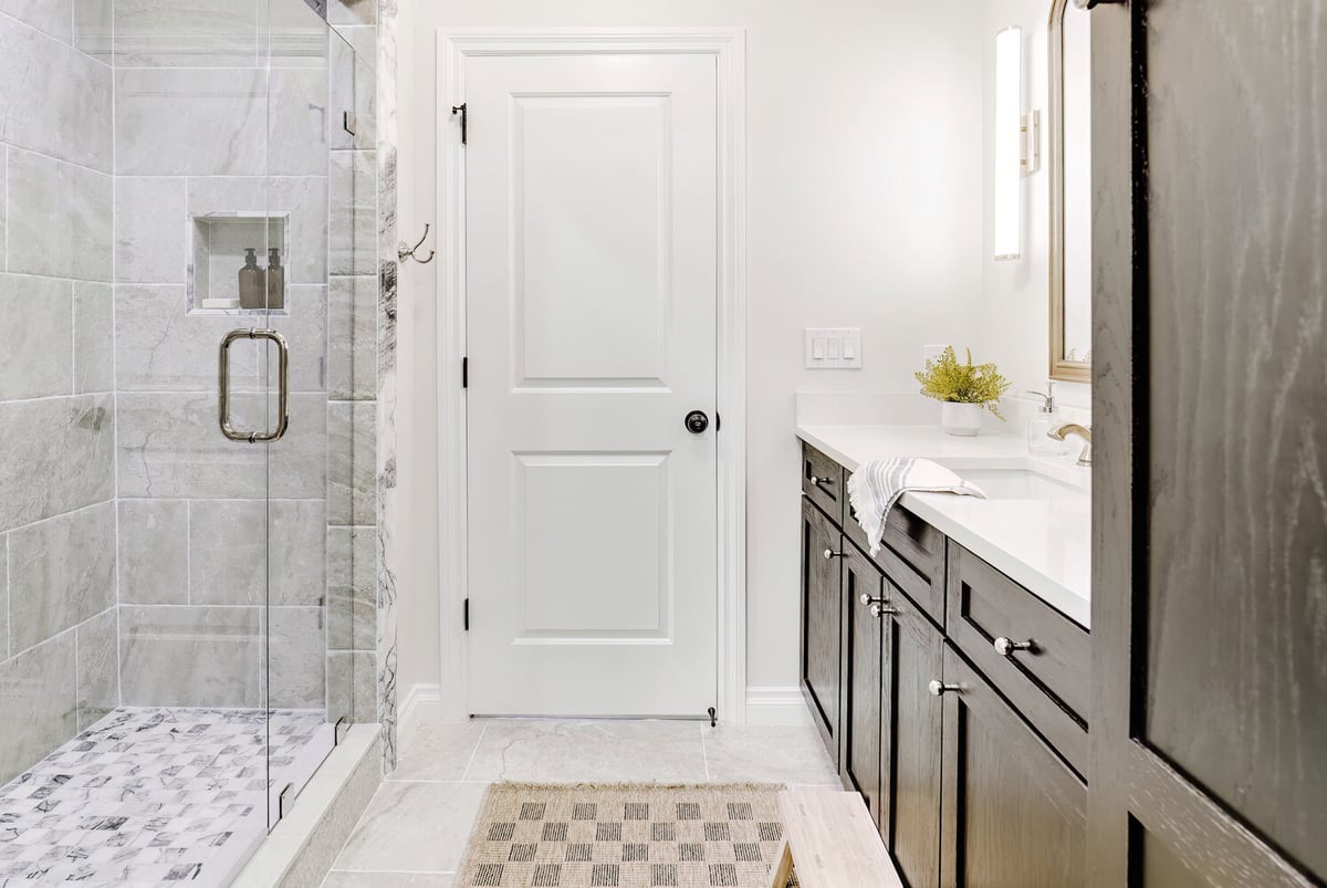 Custom shower enclosure and modern vanity design in Clarkston remodel by Cabinet Creations