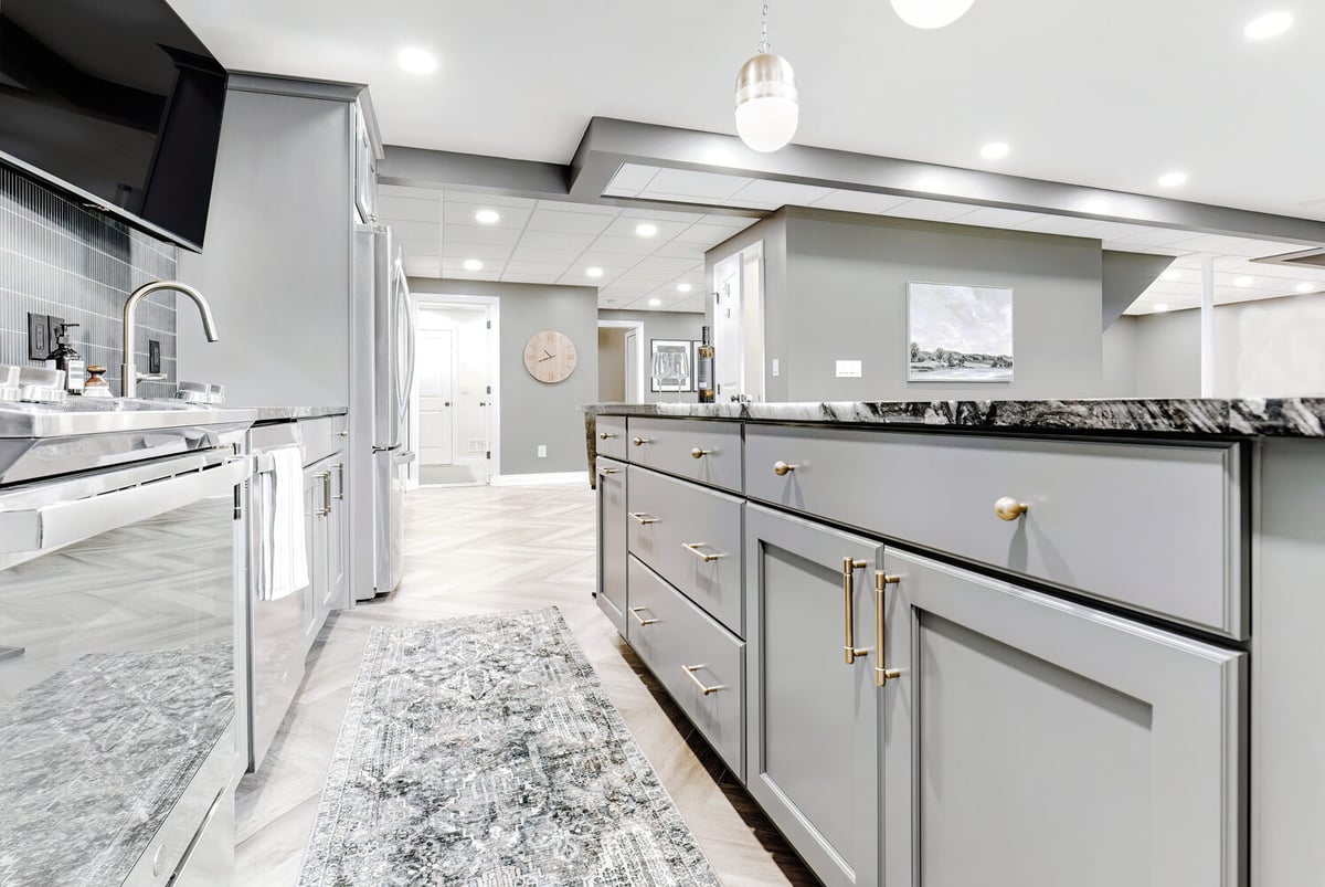 Lower-level kitchen remodel in Clarkston by Cabinet Creations with black and white tile and stainless appliances