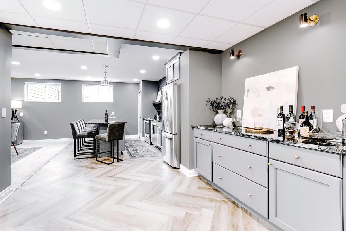 Wet bar area and open basement remodel in Clarkston by Cabinet Creations featuring modern accents