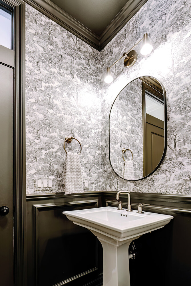 Contemporary half bath with statement wallpaper and arched mirror in Sylvan Lake, MI