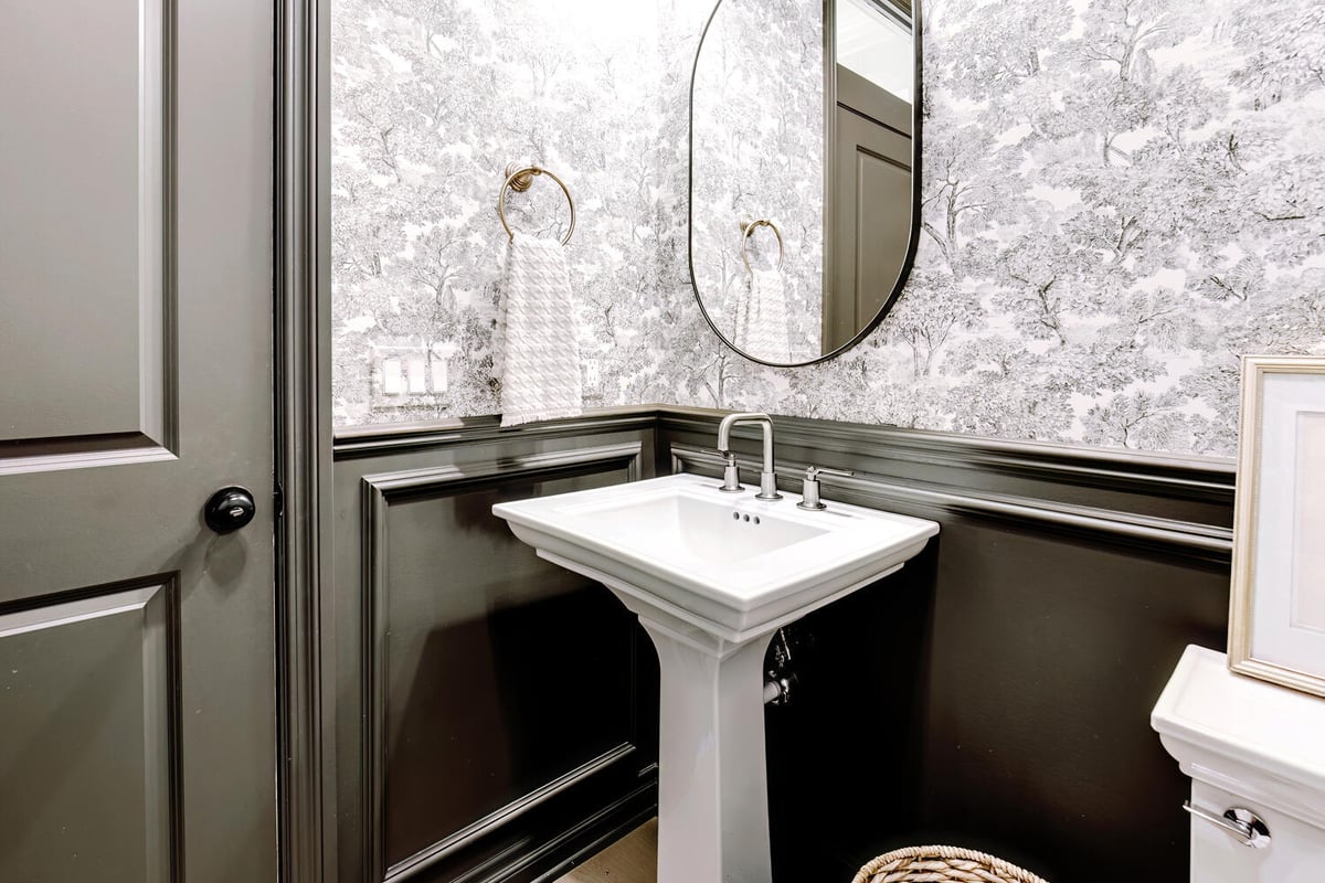 Custom-designed powder room with dark wainscoting and a minimalist sink by Cabinet Creations in Farmington, MI