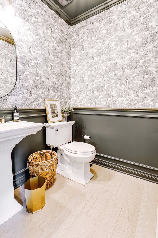 Modern powder room with decorative wallpaper and clean lines in Clarkston, MI custom home
