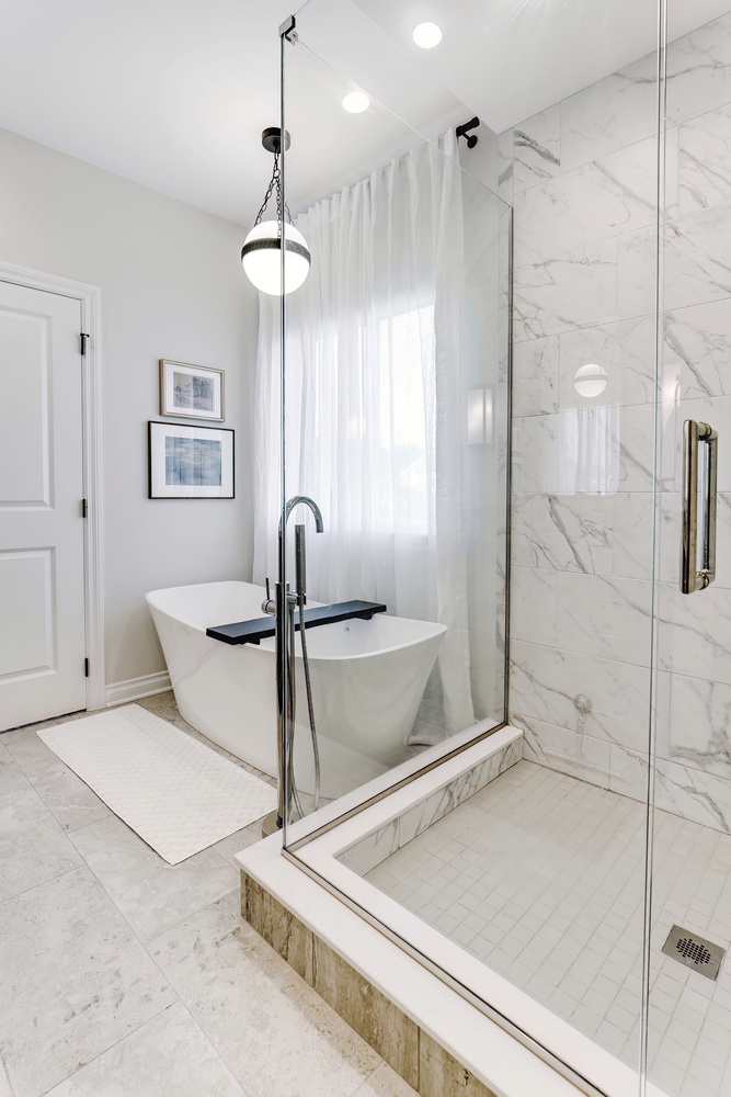 Custom bathroom with floating tub, chrome fixtures, and modern wall art in Oakland County, MI