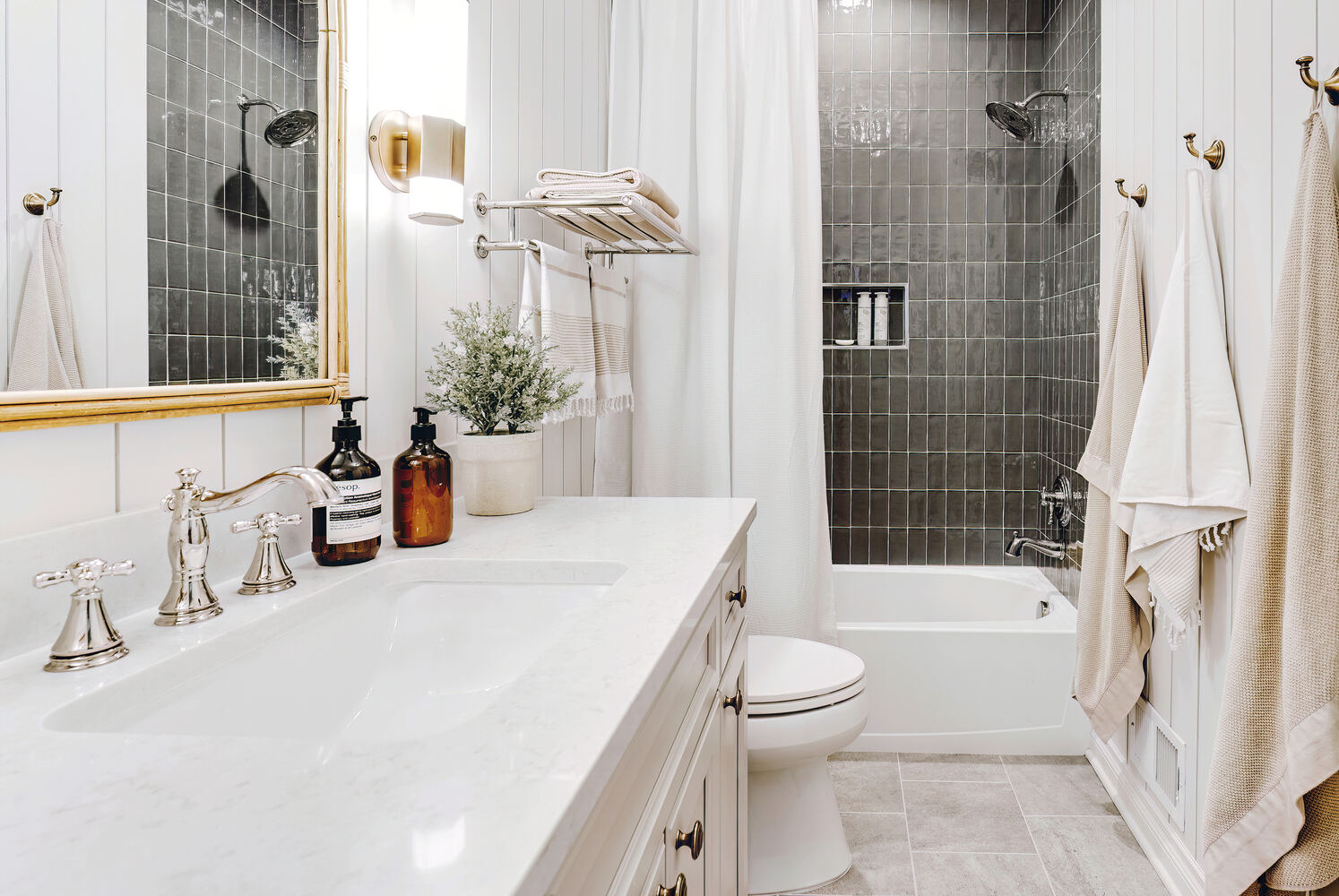 Clarkston bathroom renovation by Cabinet Creations featuring sleek vanity and modern tub-shower with black tile