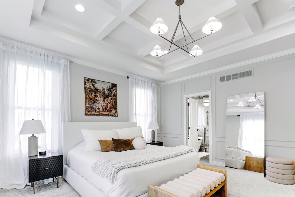 Master bedroom featuring modern lighting and elegant wall paneling in Royal Oak, MI
