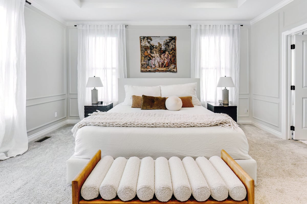 Soft-toned custom bedroom with symmetrical window layout by Cabinet Creations in Troy, MI