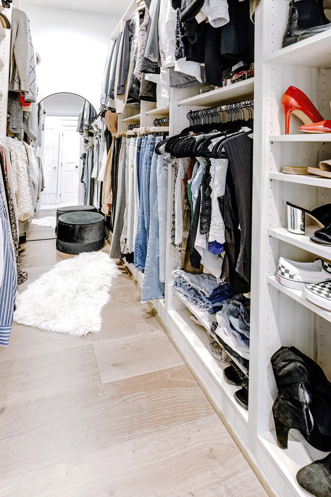 Boutique-style master closet design with shelving and neutral tones in White Lake, MI