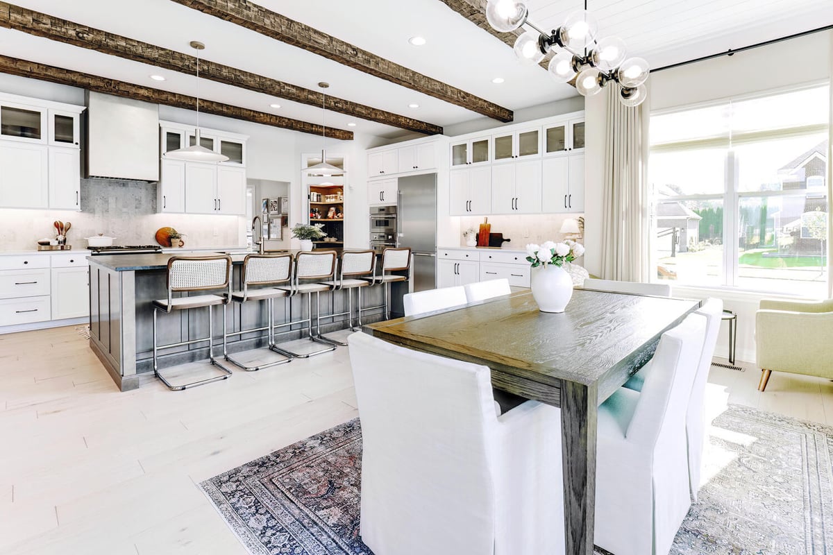 Open concept kitchen and dining room with wood beams in Waterford Township, MI