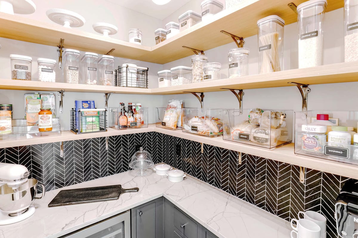 Corner pantry with open shelving and marble countertop by Cabinet Creations in Oakland County, MI