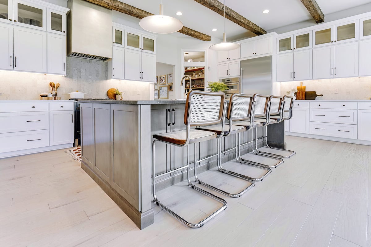 Custom kitchen layout with island seating and built-in appliances by Cabinet Creations in Commerce Township, MI
