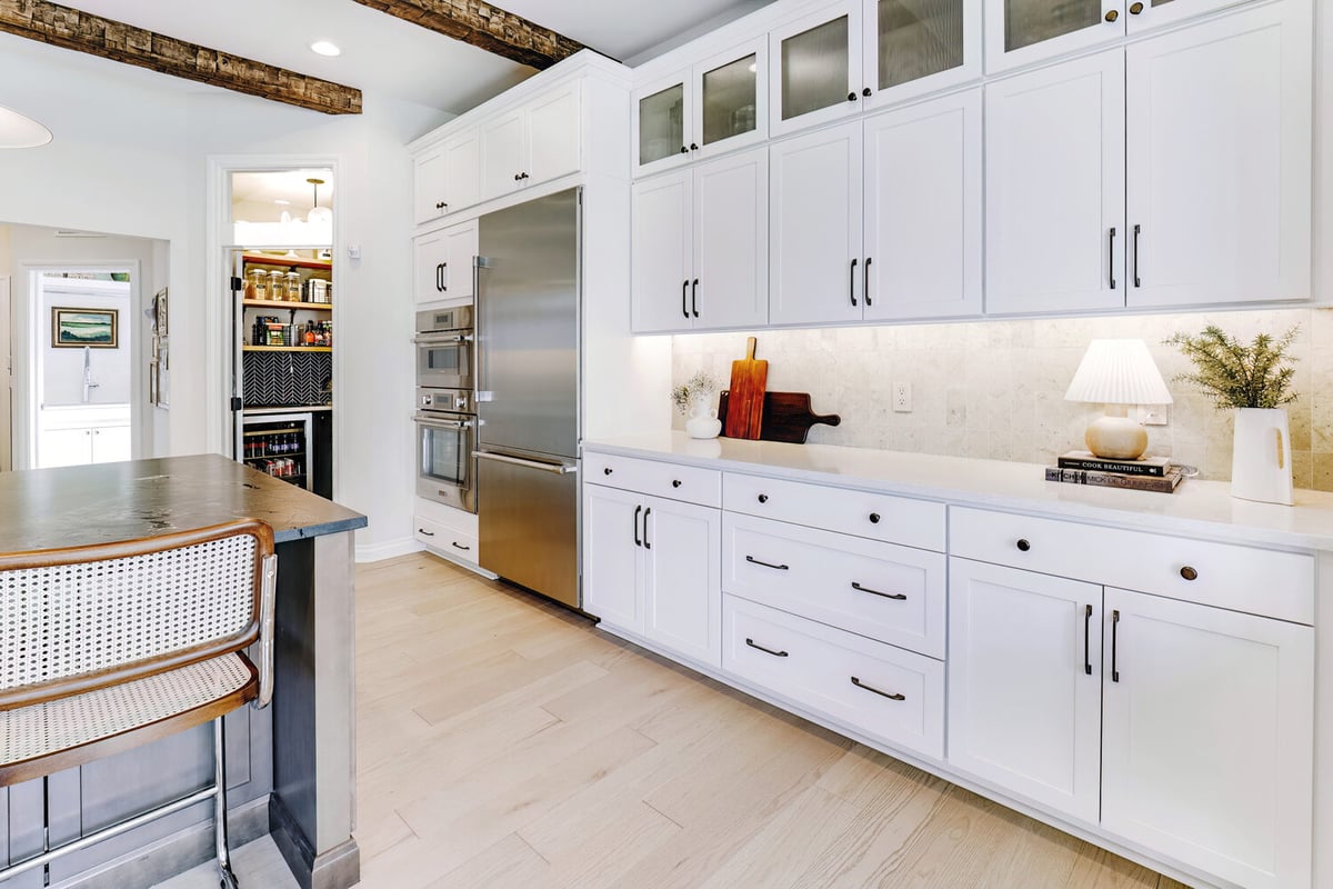 Luxury kitchen featuring glass-front cabinets and built-in appliances by Cabinet Creations in Sylvan Lake, MI