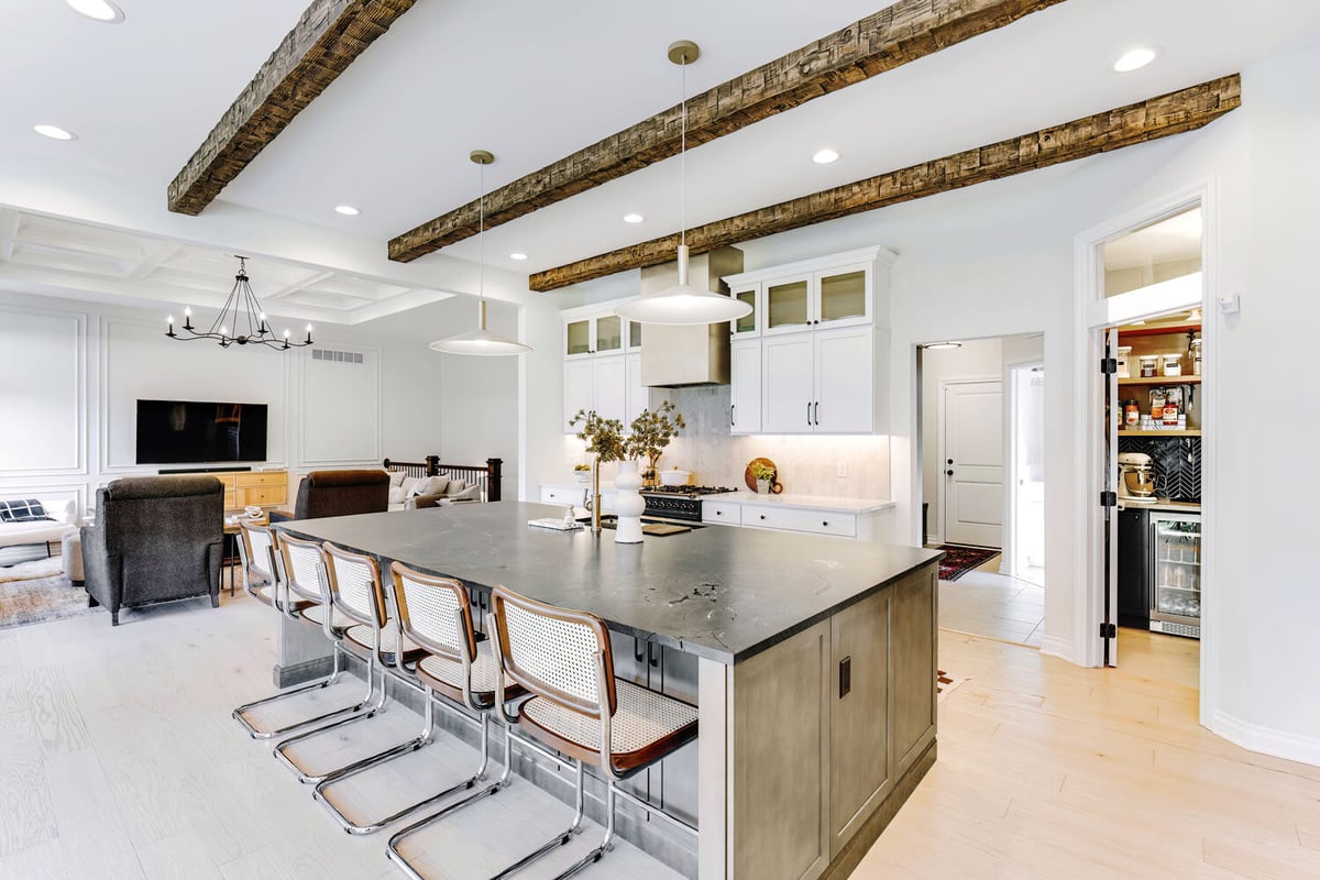 Luxury kitchen with rustic beams and pendant lights by Cabinet Creations in Troy, MI
