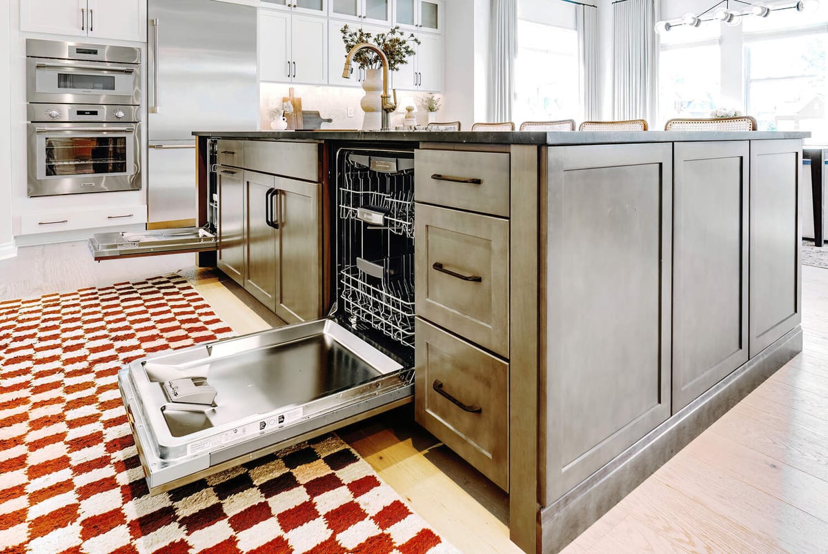 Open dishwasher drawers built into a custom kitchen island by Cabinet Creations, Oakland County, MI