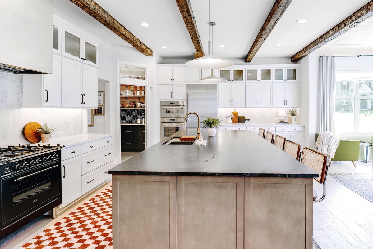 Sophisticated island kitchen with seating and backyard views in Davisburg, MI