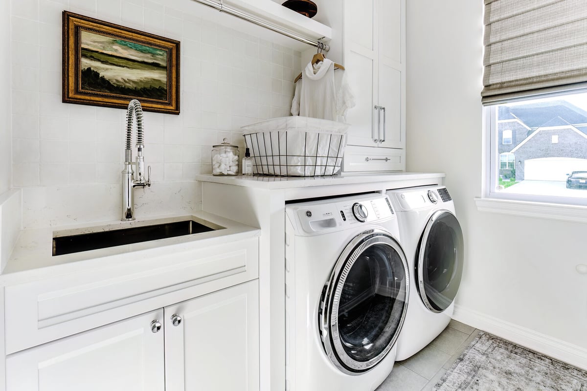 Clean and functional laundry space with modern appliances by Cabinet Creations in Oakland County, MI