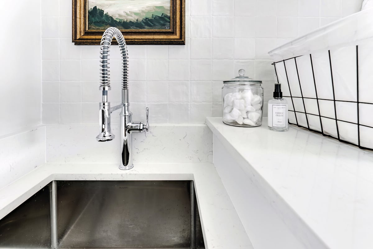 Close-up of utility sink and chrome faucet in a custom laundry room by Cabinet Creations, Oakland County, MI