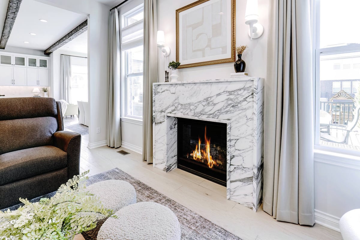 Fireplace corner view with elegant trim and natural lighting by Cabinet Creations, Oakland County, MI