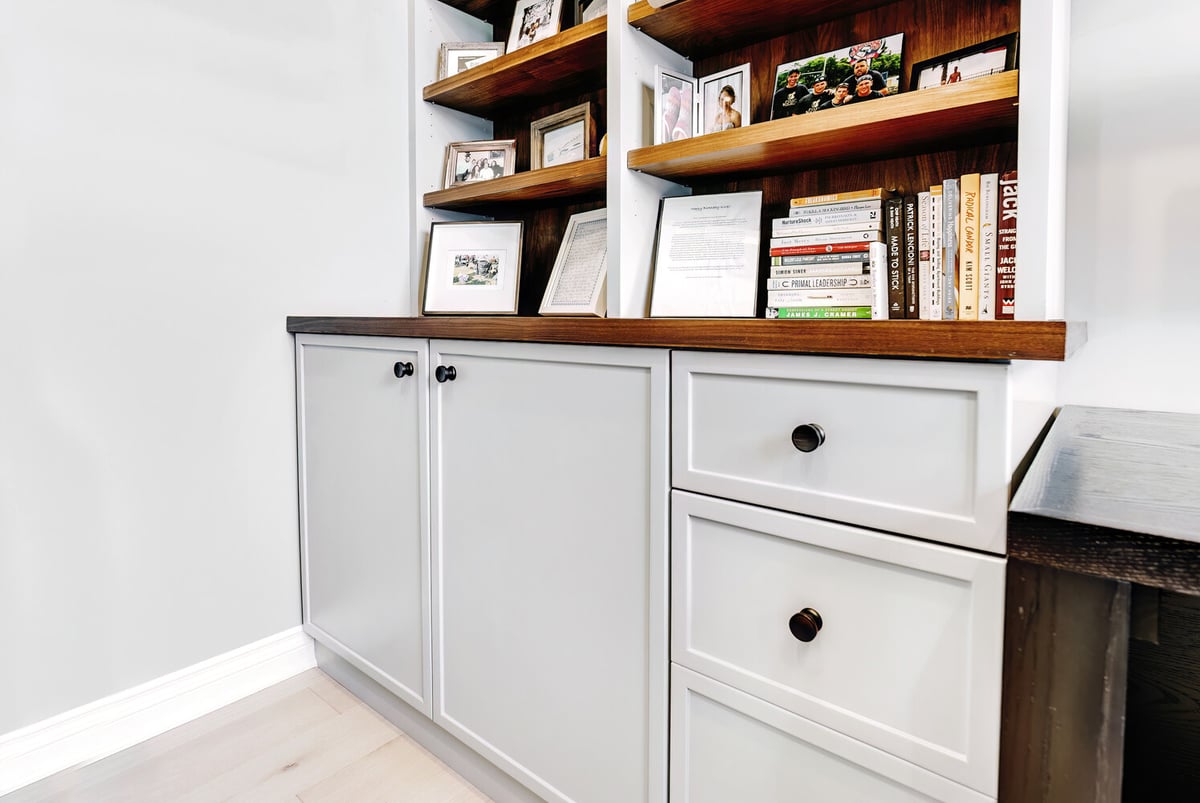 Lower cabinets and wood-top shelving in a custom home office by Cabinet Creations in Michigan