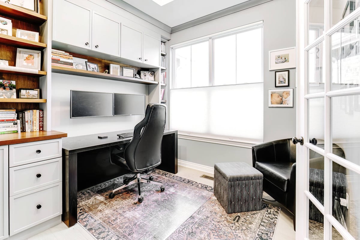 Window-lit office with custom storage and seating designed by Cabinet Creations in Oakland County, Michigan