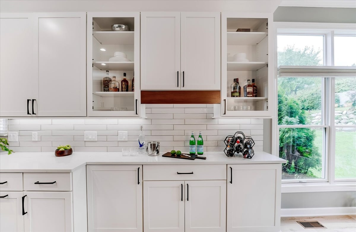 Beverage station with open shelves and wine rack in a custom home kitchen by Cabinet Creations, MI