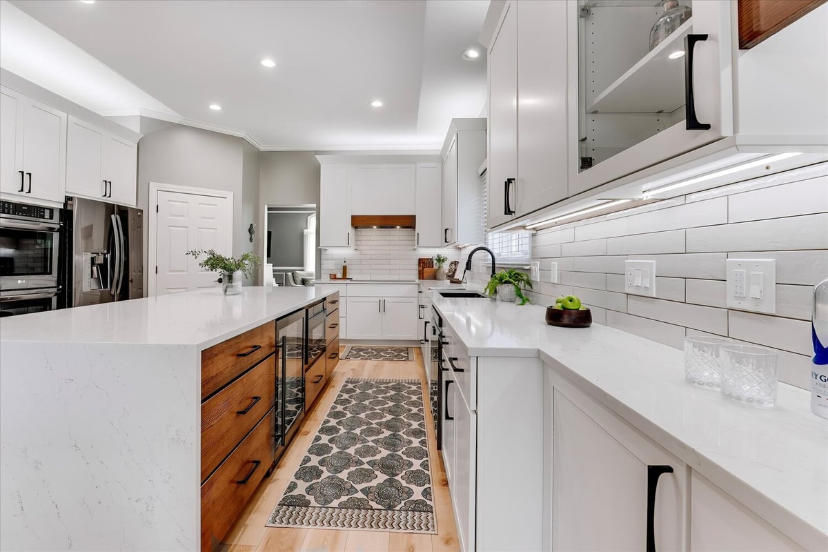 Custom kitchen featuring dual-tone island and beverage fridge by Cabinet Creations in Michigan