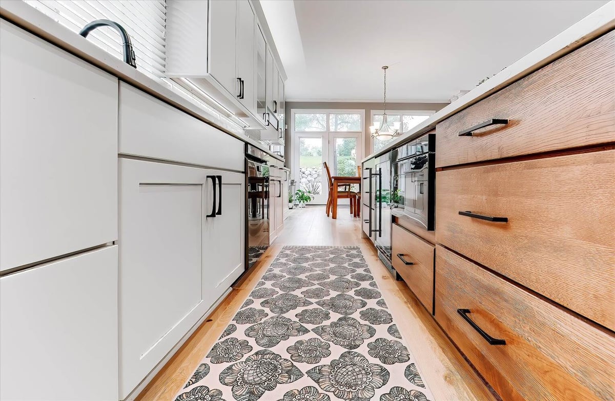 Custom kitchen island with wood drawers and built-in beverage cooler in Oakland County by Cabinet Creations