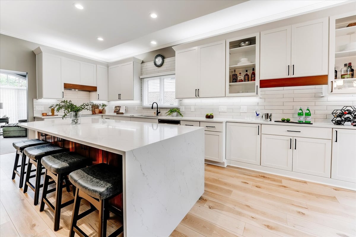 Full kitchen view with quartz island and white cabinets by Cabinet Creations in Oakland County, MI