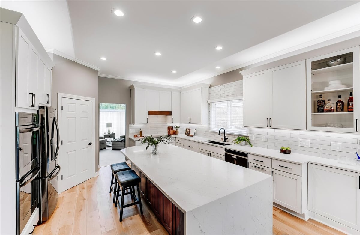 Transitional kitchen with large island and dual seating by Cabinet Creations in Michigan