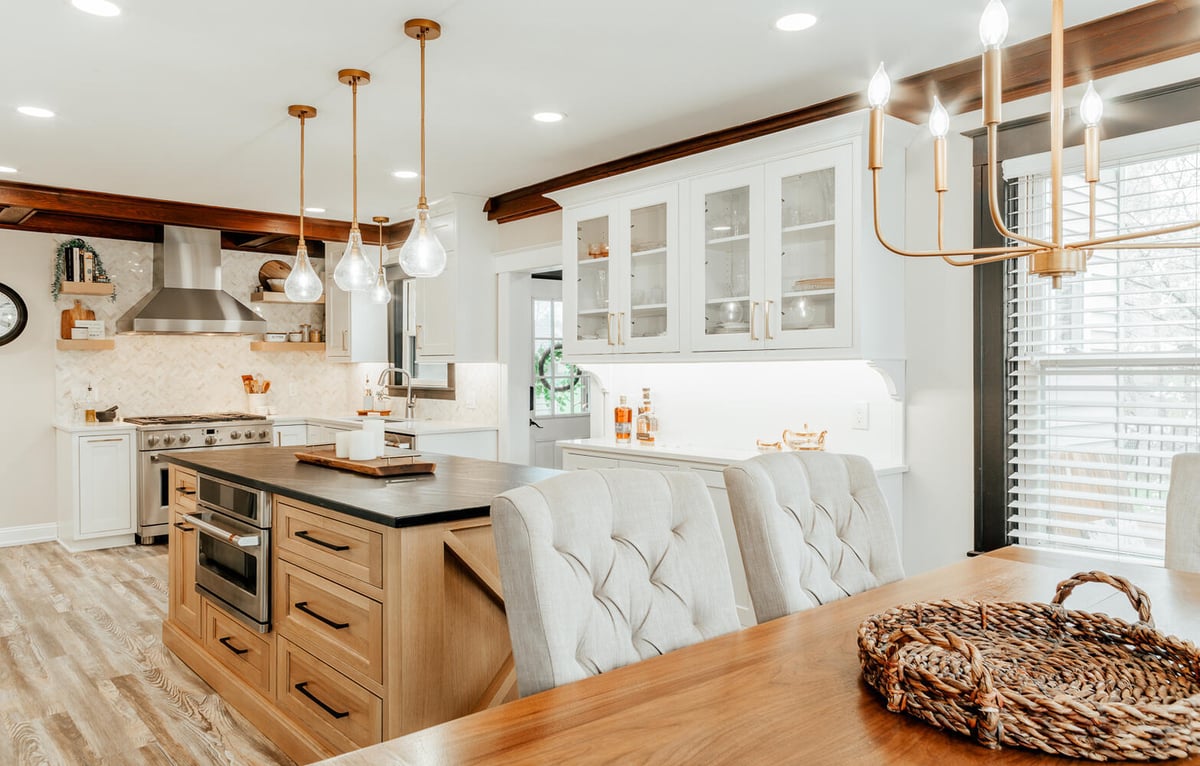 Bright custom kitchen and dining area with natural wood island by Cabinet Creations in Lake Orion, MI