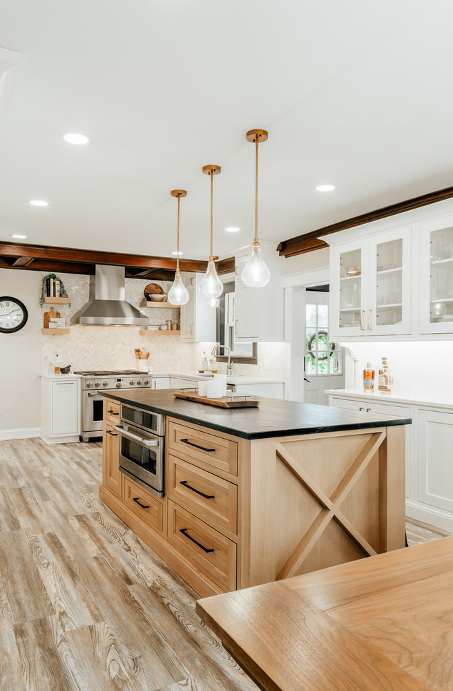 Custom kitchen remodel featuring white cabinetry and wood island base by Cabinet Creations in Oakland County, MI