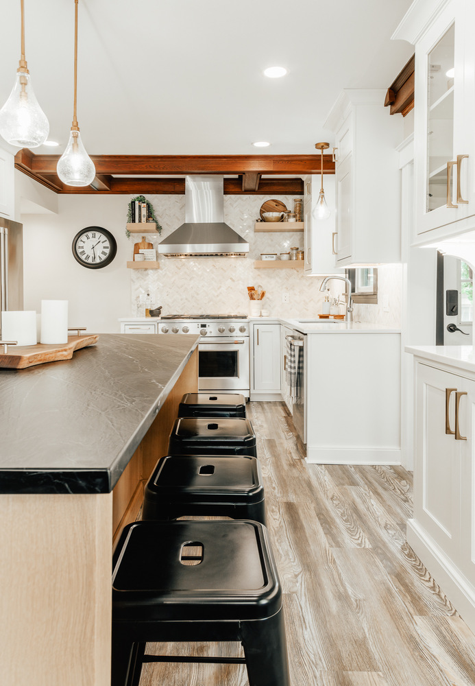 Elegant kitchen with herringbone tile wall and open shelving by Cabinet Creations in Lake Orion, MI