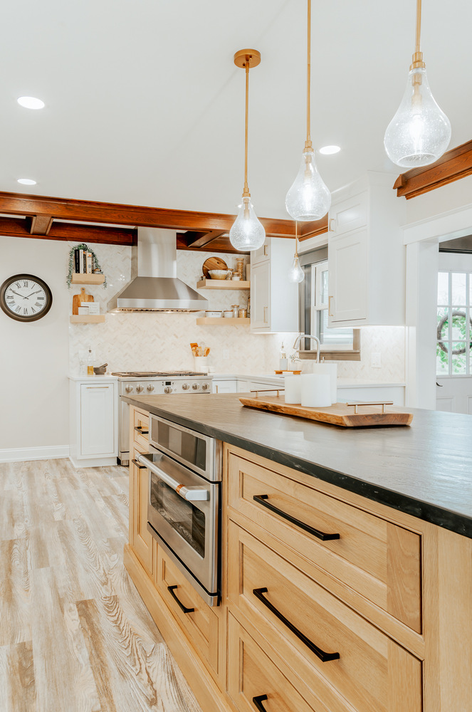 Lake Orion custom home kitchen with wood island and white cabinets by Cabinet Creations