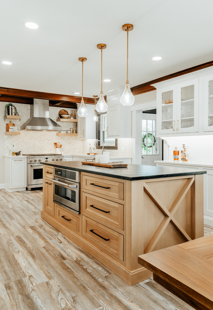 Open kitchen design with mixed materials and brass lighting by Cabinet Creations in Oakland County, MI
