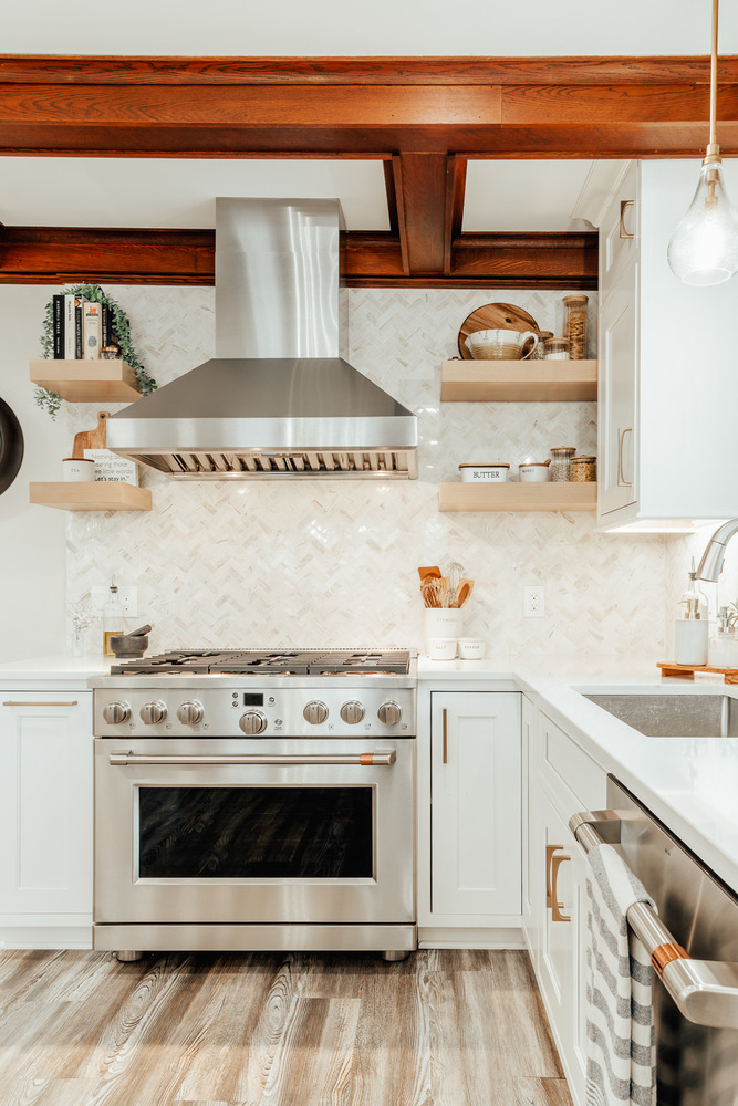 Stainless steel gas range with custom tile backsplash by Cabinet Creations in Lake Orion, MI