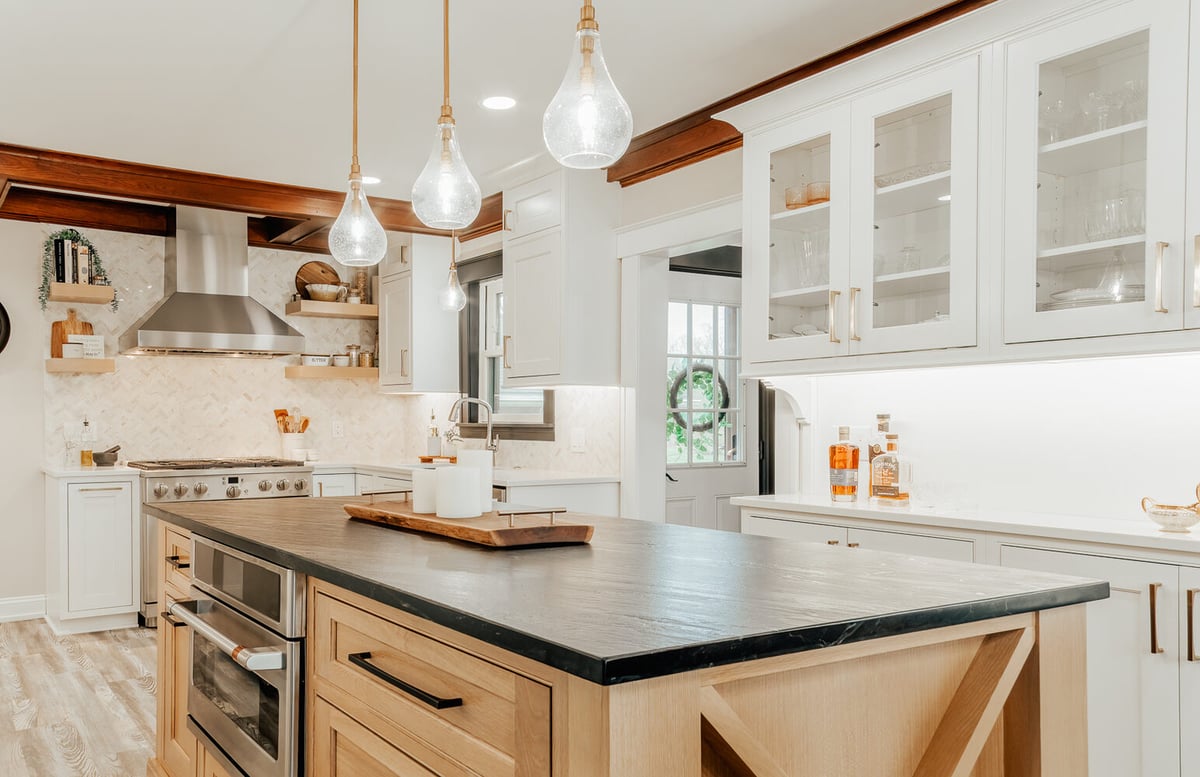 Warm modern kitchen featuring natural wood finishes and white cabinetry by Cabinet Creations in Oakland County, MI