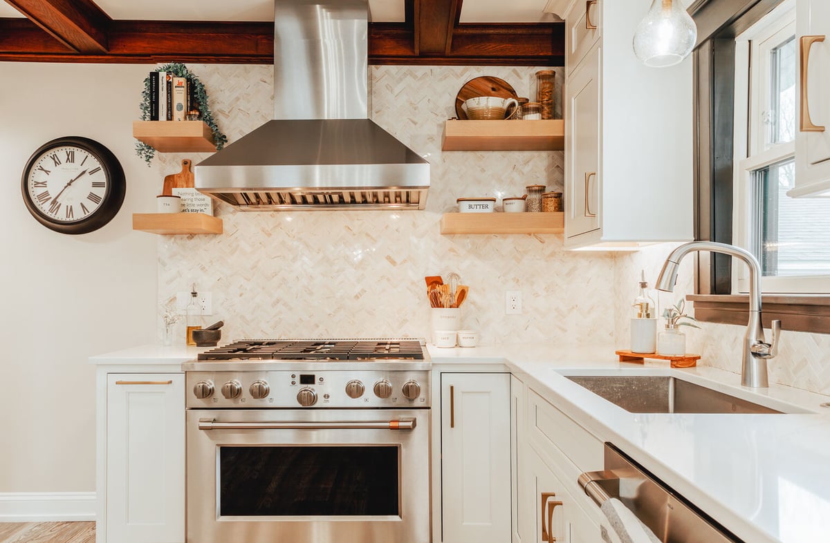 White kitchen with stainless steel range and herringbone backsplash by Cabinet Creations in Lake Orion, MI