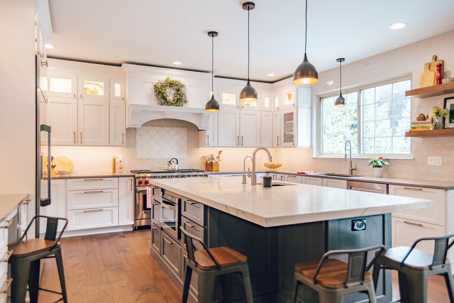 Elegant kitchen design with white shaker cabinets and black accents by Cabinet Creations in White Lake, MI