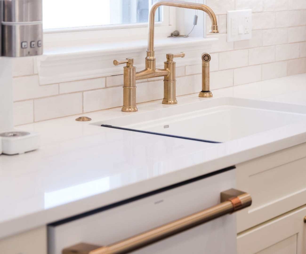 Brushed gold kitchen faucet and white sink installation by Cabinet Creations in Ferndale, MI