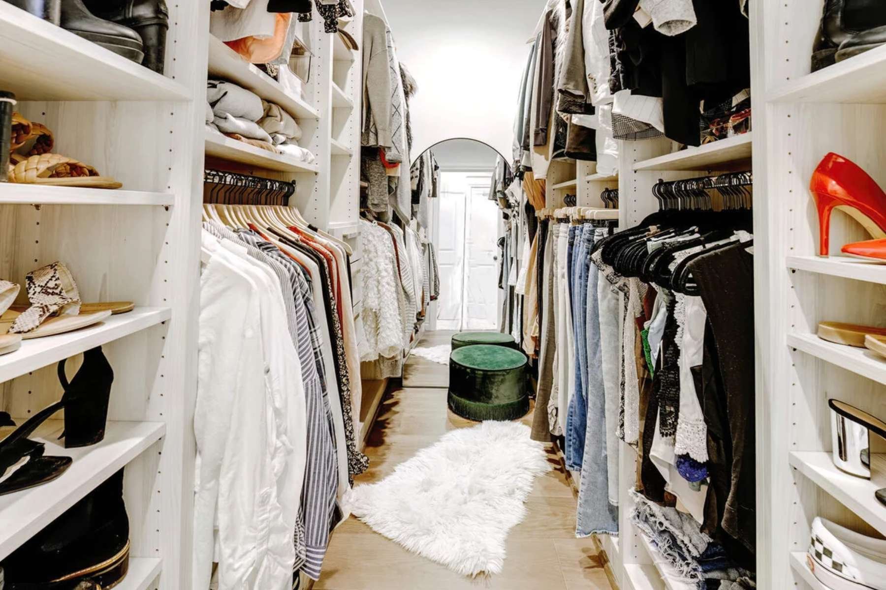 Custom walk-in closet in Rochester, MI by Cabinet Creations featuring built-in storage and display shelving